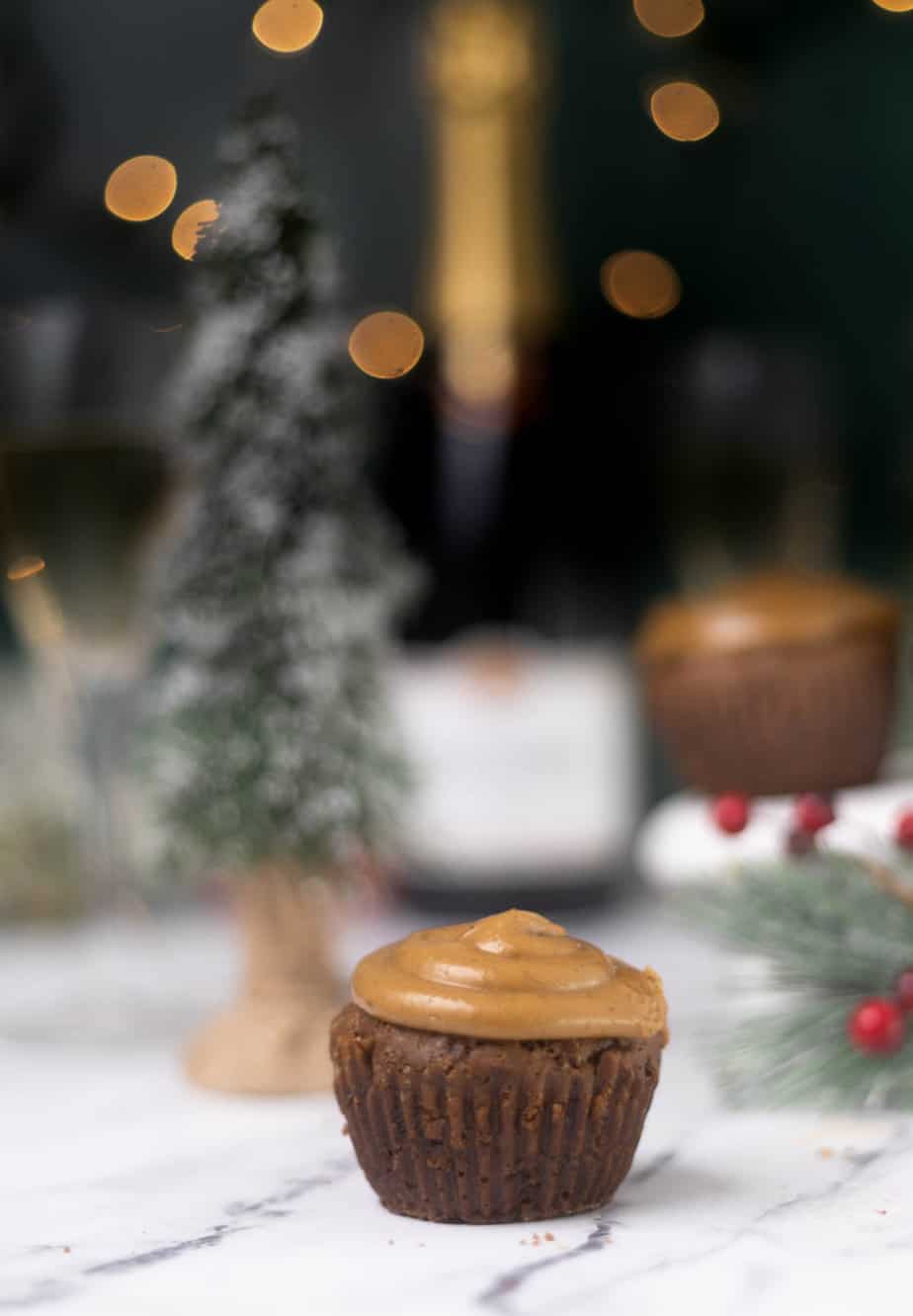 Gingerbread cupcake  with greenery for Christmas in the background 