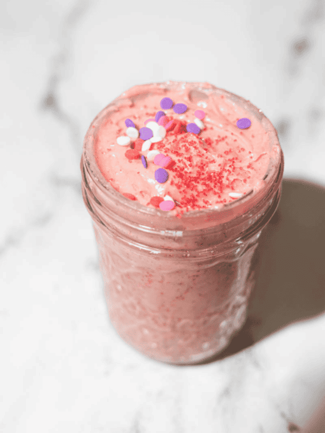 sugar cookie dip with sparkles on top (purple, white, pink) in am mason jar showing inside