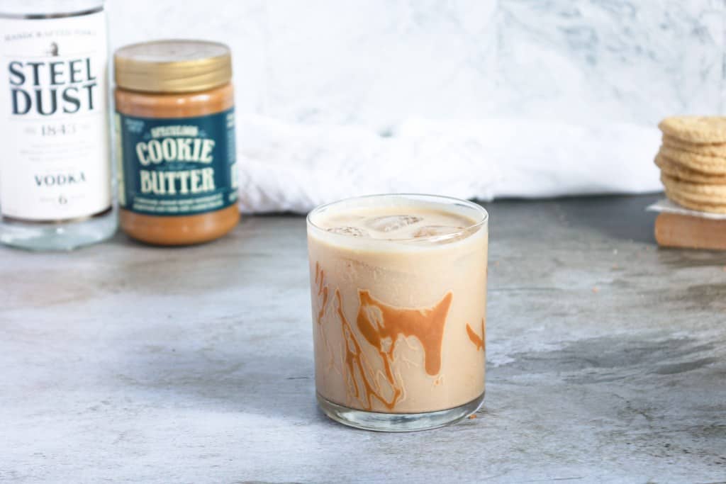 Cookie Butter Cocktail with cookie butter in background