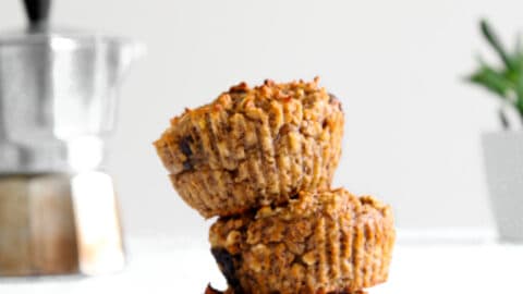 Chocolate Banana Protein Muffin in a stack (3) with a coffee perker and plant in back