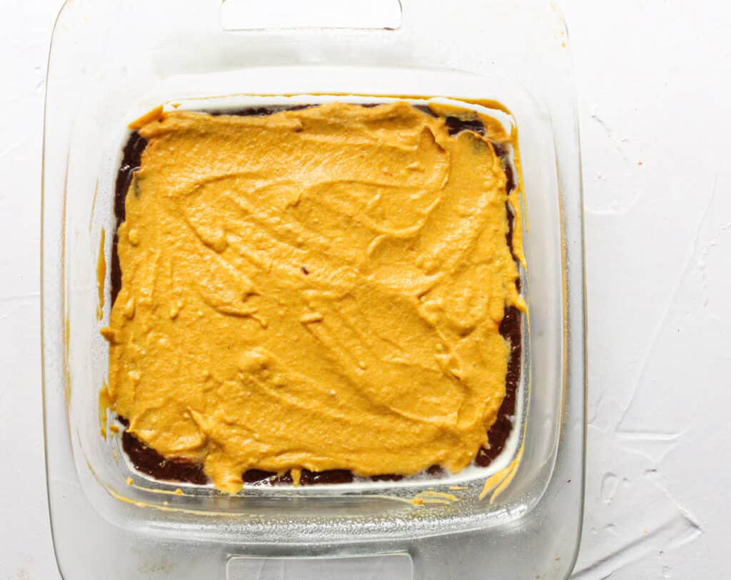 vegan brownies with the pumpkin layer spread over the top