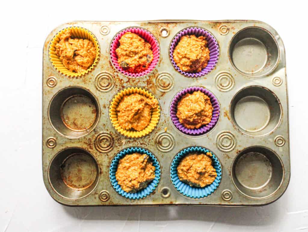 vegan pumpkin muffins in a muffin pan before baking.