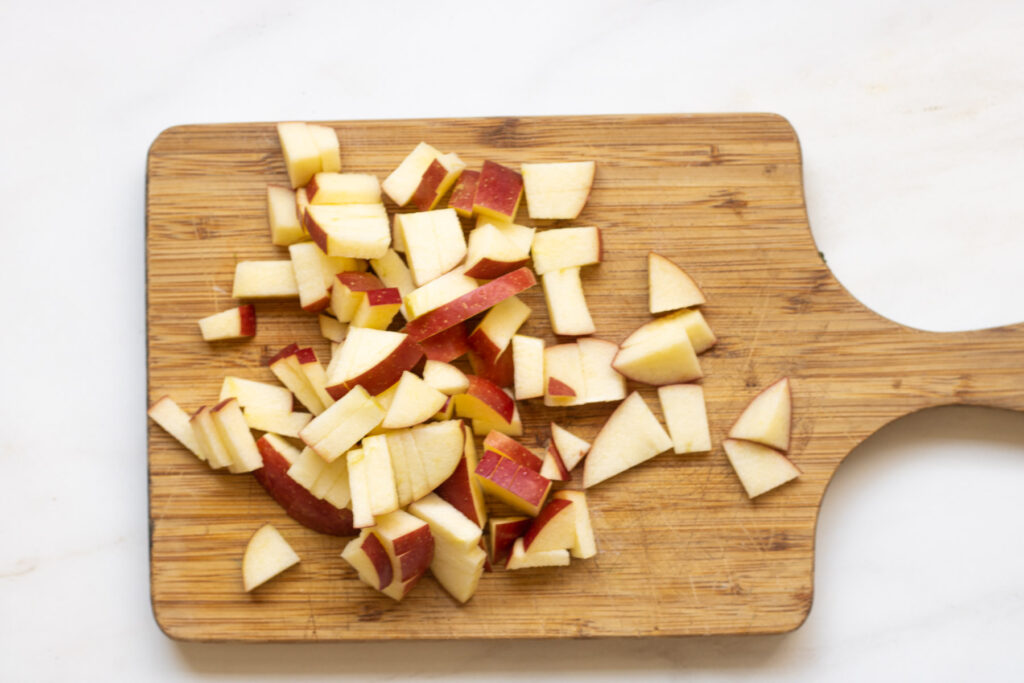 Apple cut into bite size pieces on a cutting board