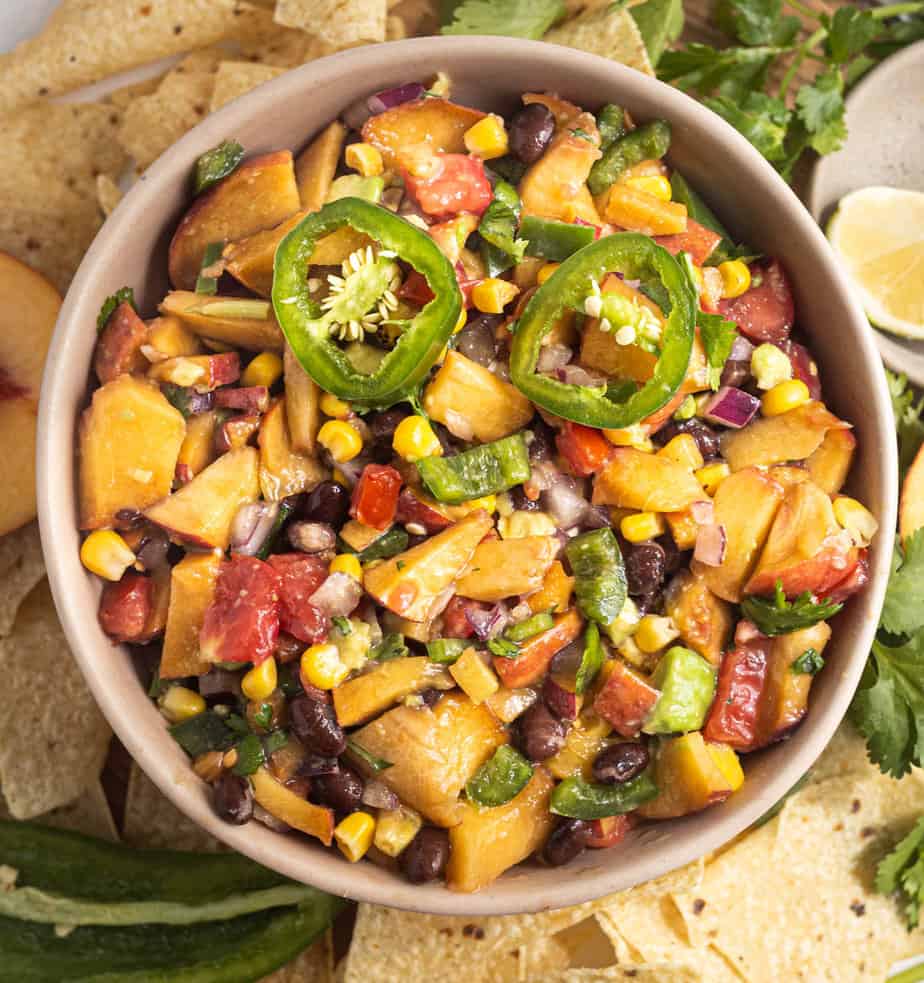 Jalapeno peach salad in a bowl up close showing all the veggies and fruit cut up