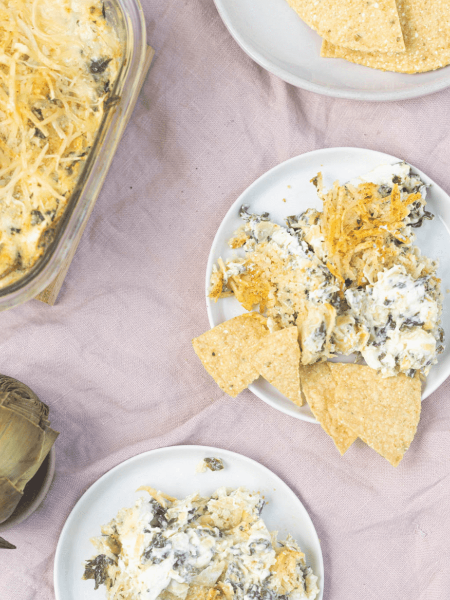 spinach artichoke dip in plates with chips surronding it