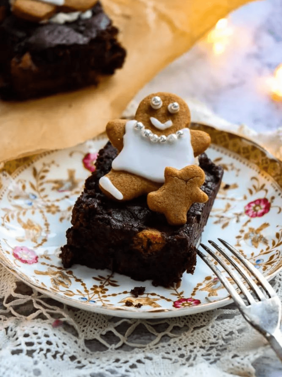 gingerbread brownie on a plate with a fork next to it and gingerbread man on top