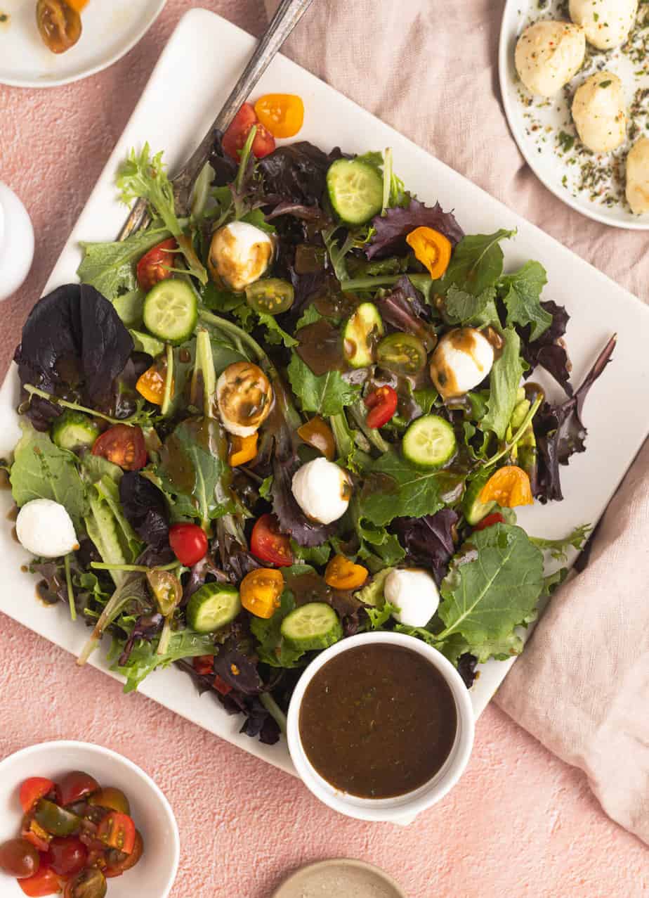 Basil Balsamic Dressing on a mixed salad with with the drizzle all over the top