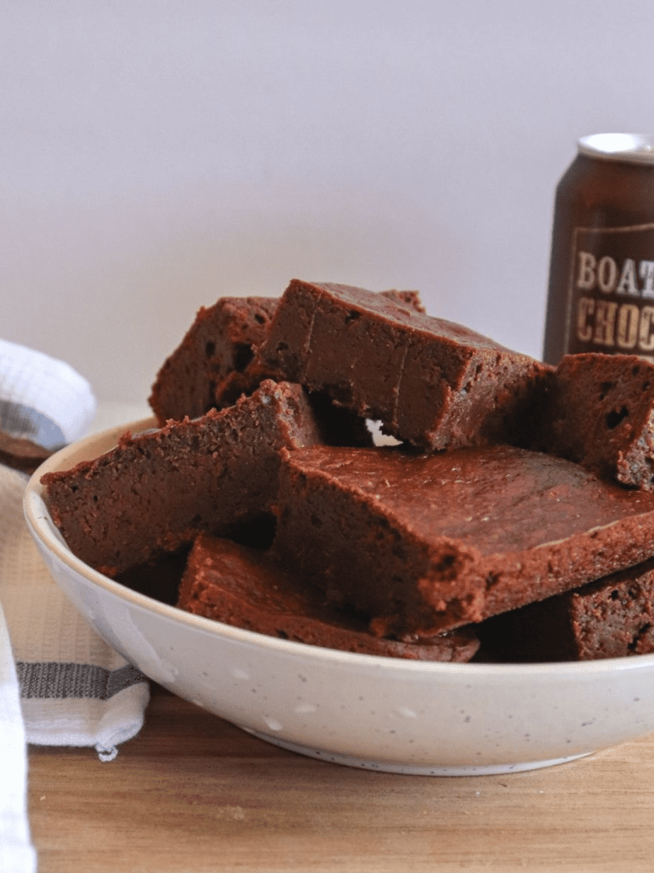 boozy brownies in a bowl with a can of beer in the background 