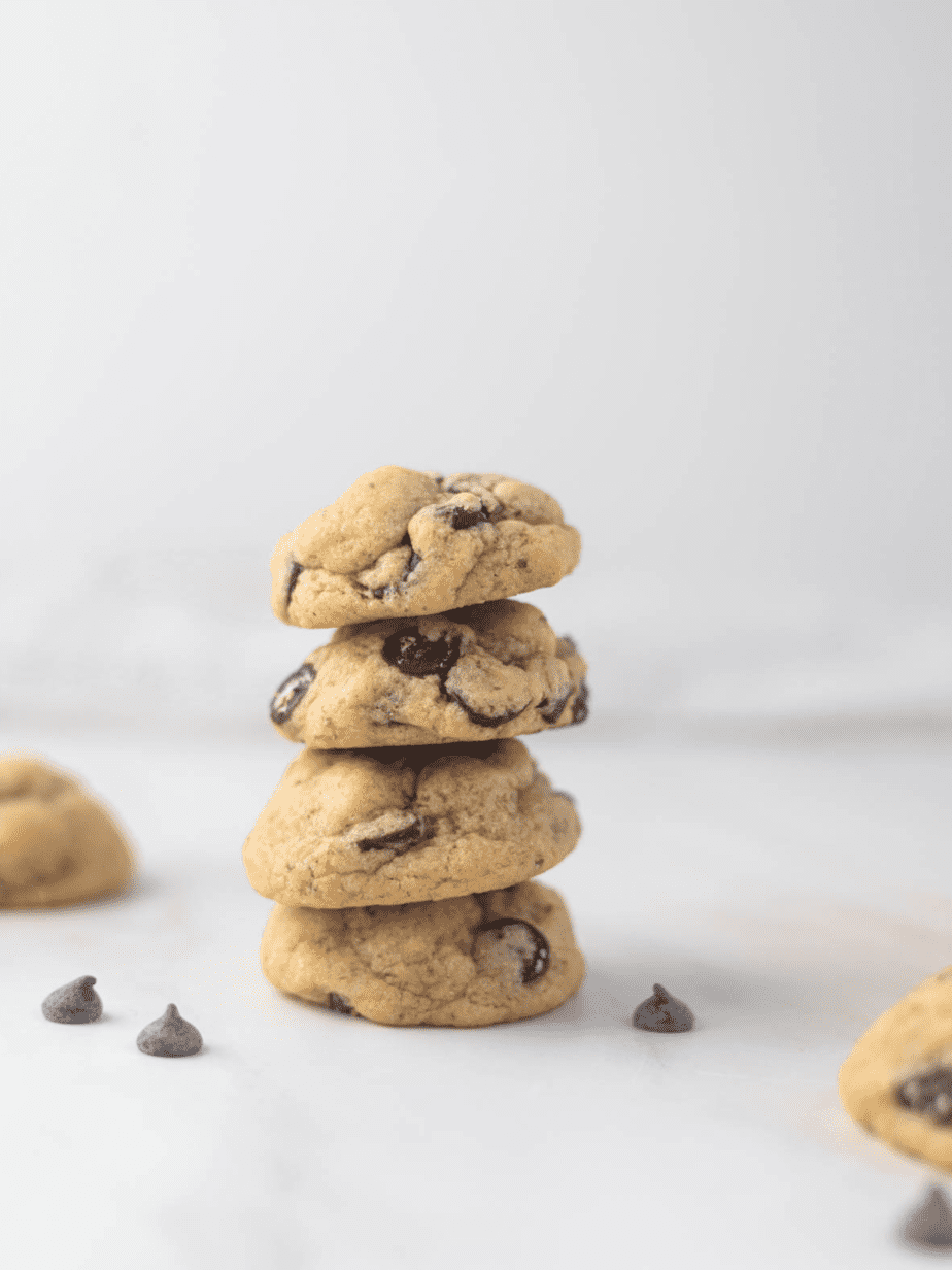 Dairy Free Chocolate Chip Cookies four on a stack with a cookie in the background