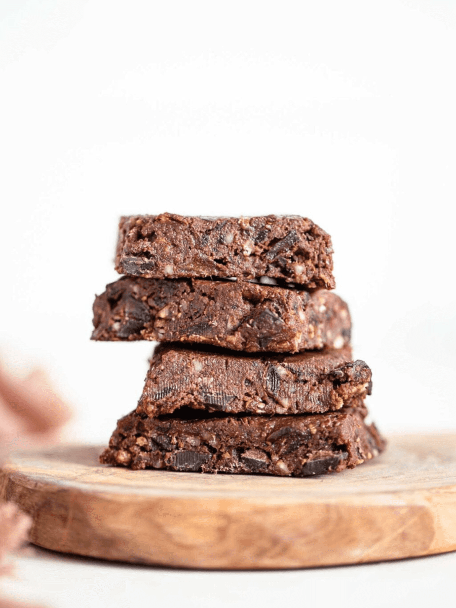 double chocolate raw brownies cut into pieces and stacked on each other