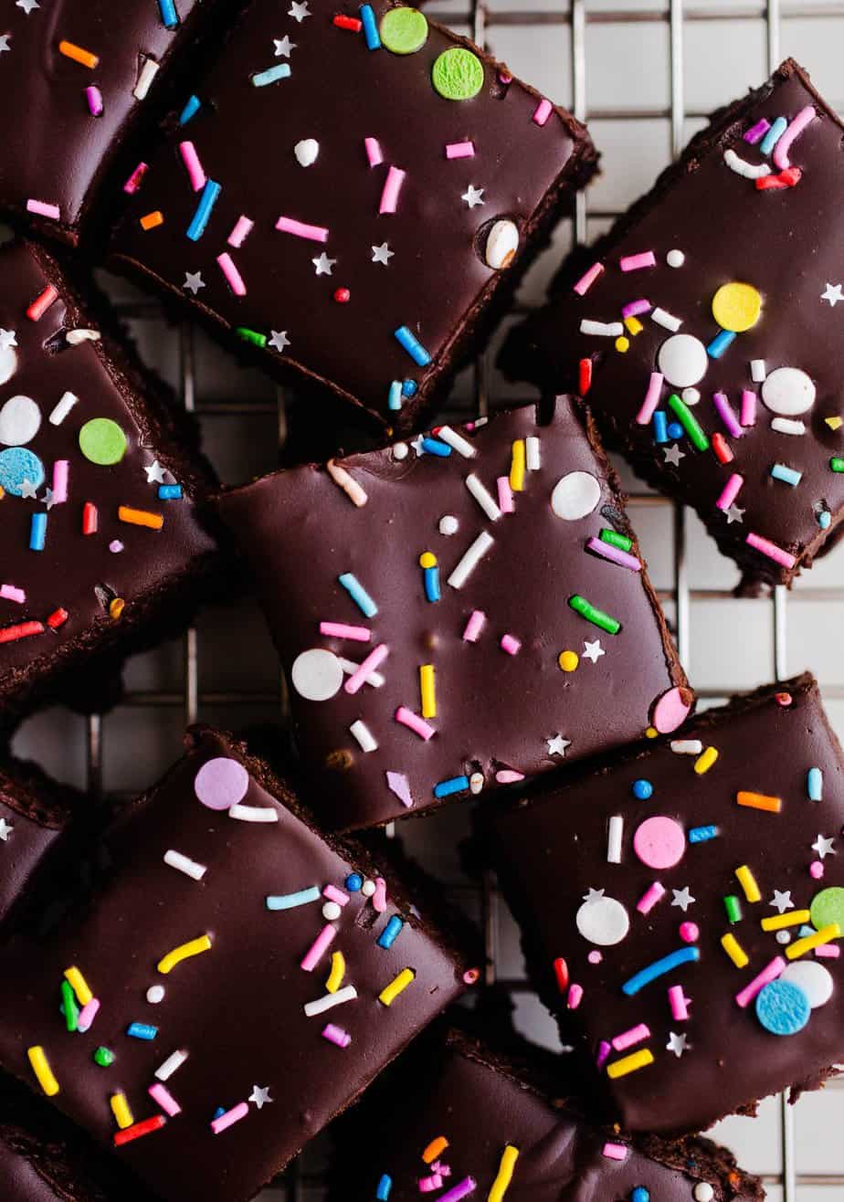 brownies with sprinkles on top cut into squares on a cooling rack