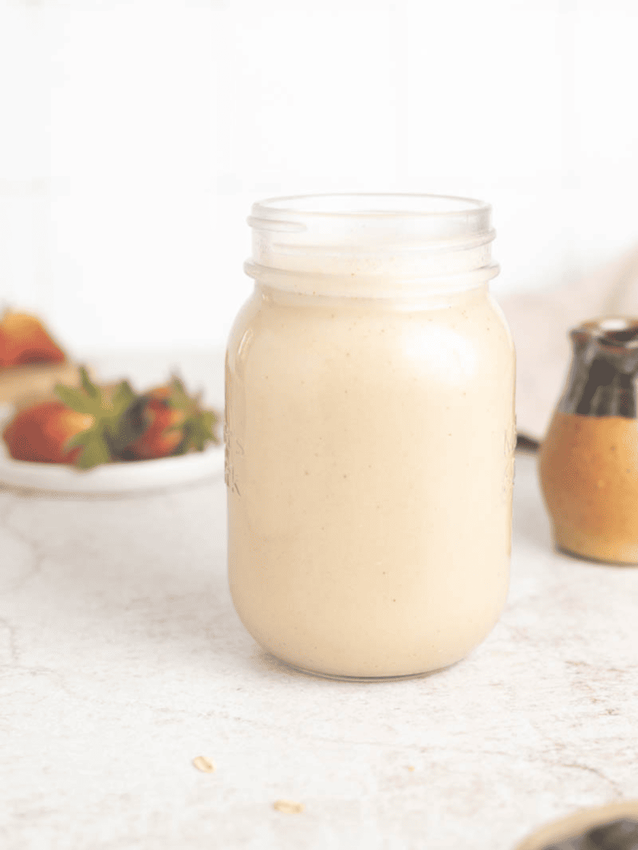 Oat milk coffee creamer in a mason jar fully mixed together with all ingredients in the jar