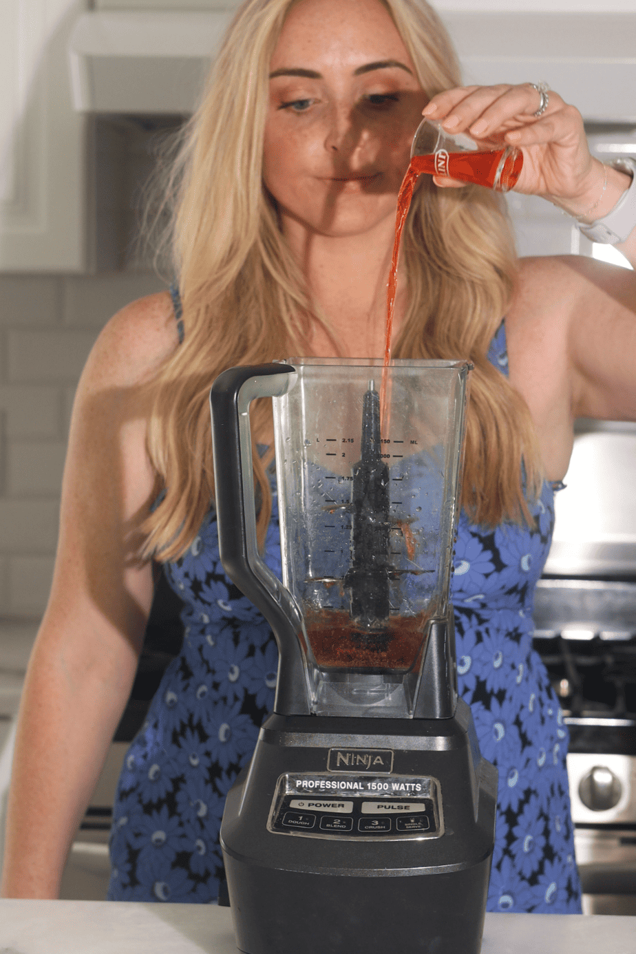 Chelsea adding all  liquid ingredients into a blender