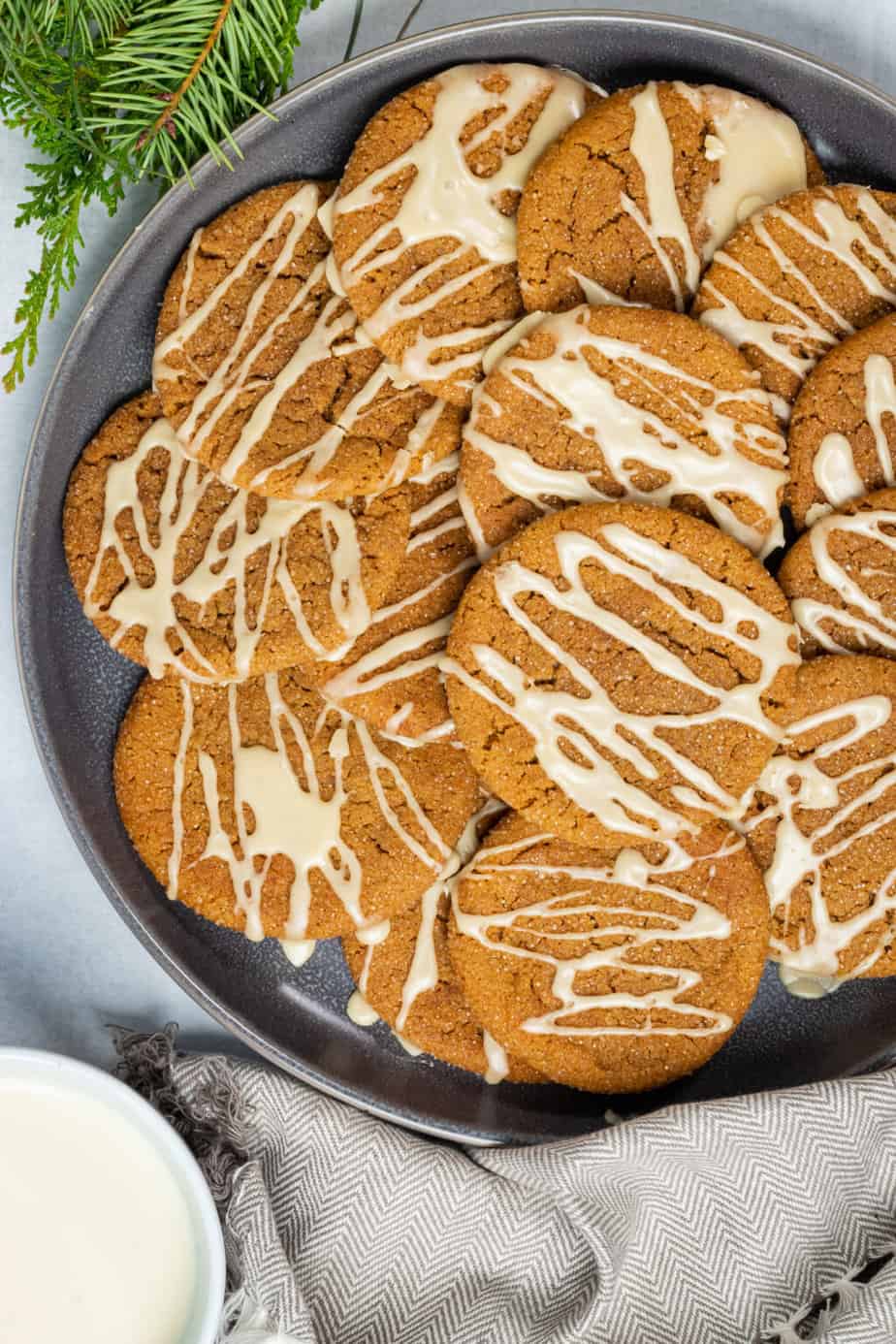 ginger cookies on a plate with white drizzle all over them