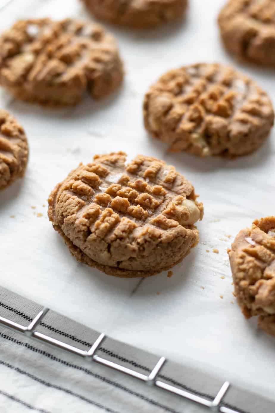 cashew butter cookies on parchment paper on a wire rack